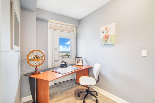 home office with wood tiled floor and baseboards