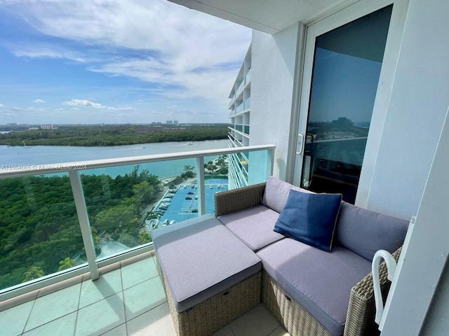 balcony with an outdoor hangout area and a water view