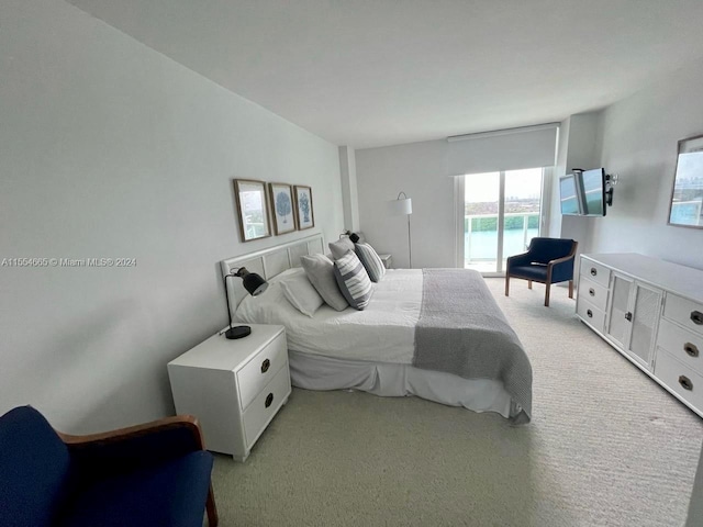 carpeted bedroom featuring access to exterior and vaulted ceiling