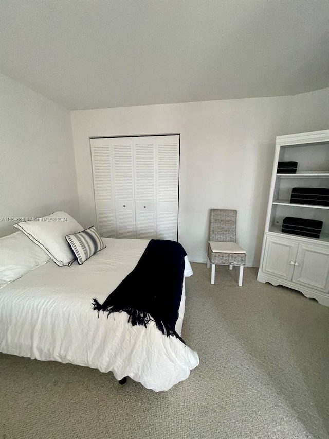 carpeted bedroom with a closet