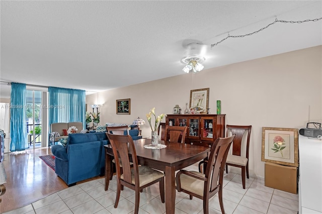 tiled dining area featuring ceiling fan