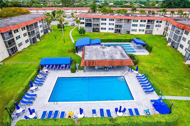 view of swimming pool with a lawn and a patio