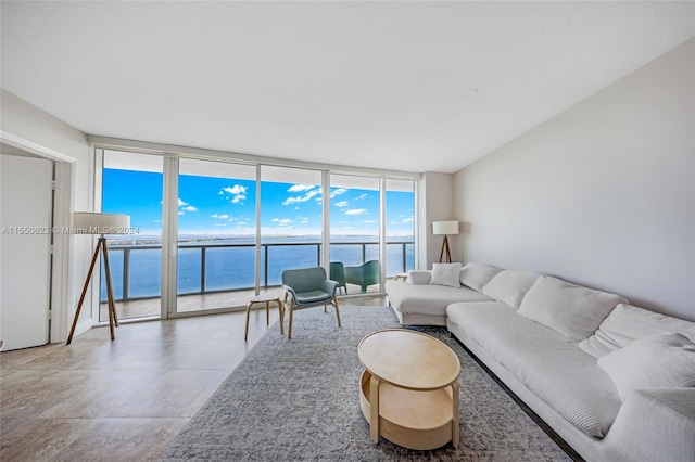 living room with floor to ceiling windows, a water view, and tile floors