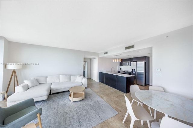 living room with sink and concrete floors