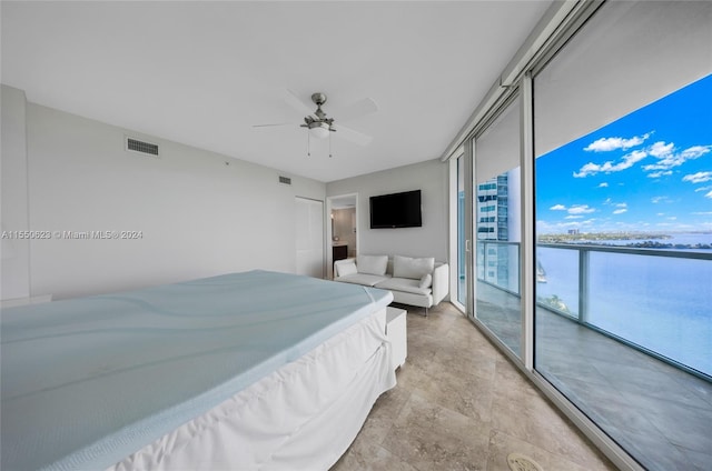 bedroom featuring access to exterior, a wall of windows, and ceiling fan