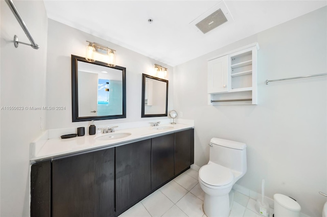 bathroom featuring tile flooring, large vanity, toilet, and double sink