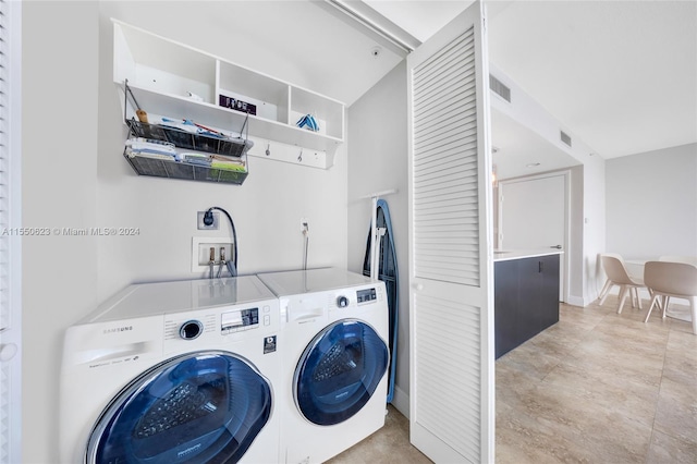 laundry area with washing machine and dryer, washer hookup, light tile flooring, and hookup for an electric dryer