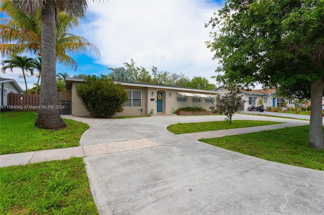 ranch-style home with a front lawn