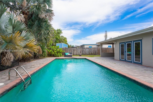 view of pool with a patio area and french doors