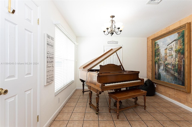 misc room with an inviting chandelier and light tile flooring