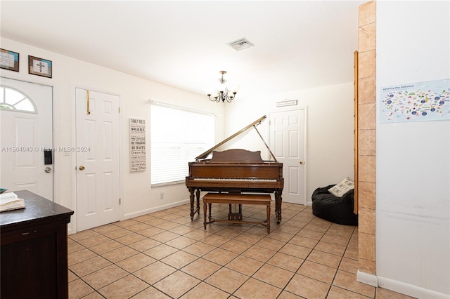 misc room featuring light tile floors and a chandelier