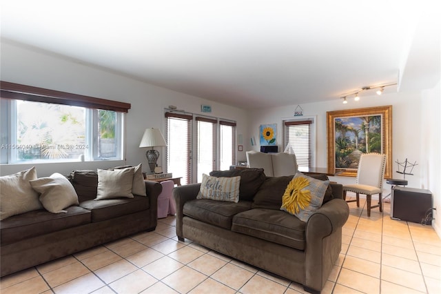 living room with track lighting and light tile flooring