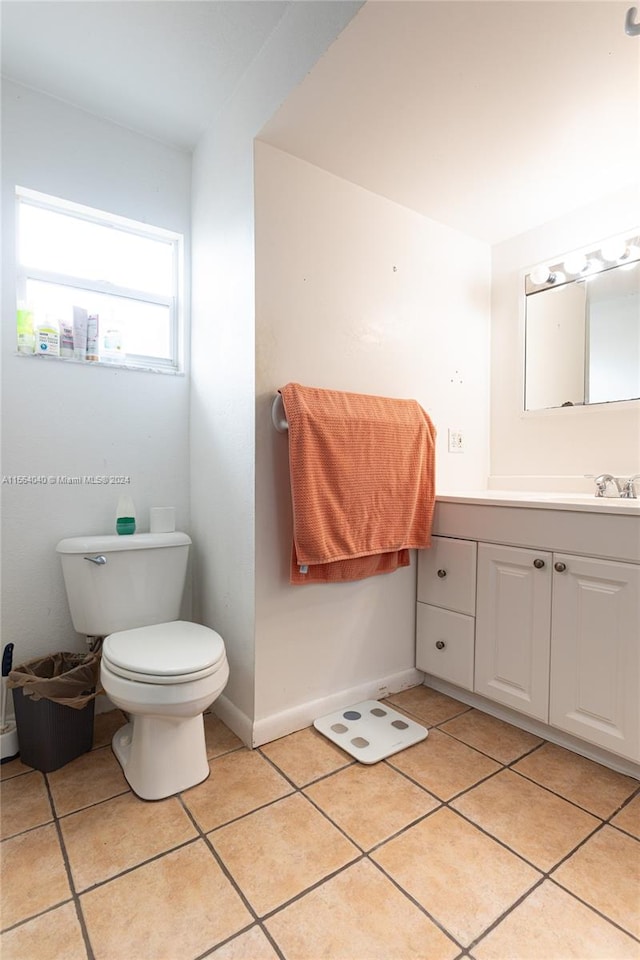 bathroom with vanity, tile floors, and toilet