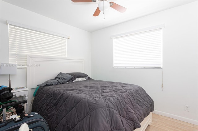 bedroom with light hardwood / wood-style floors and ceiling fan