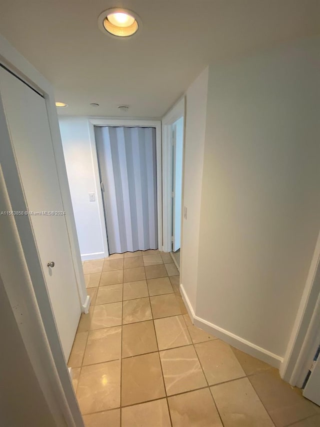 hallway featuring light tile patterned flooring