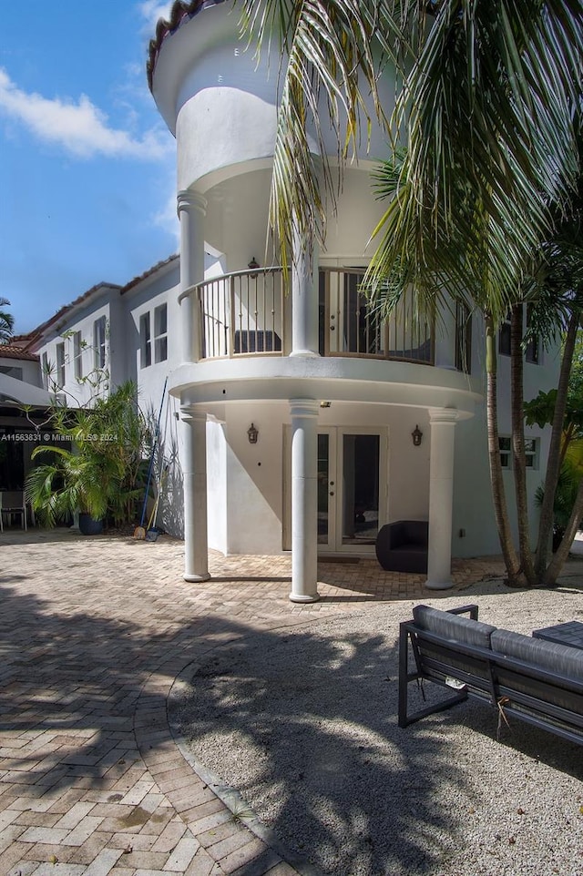 back of house with a patio and a balcony