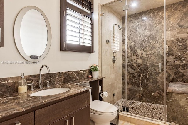 bathroom with toilet, walk in shower, and oversized vanity