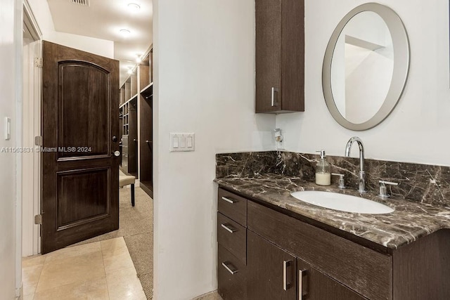 bathroom with tile floors and vanity