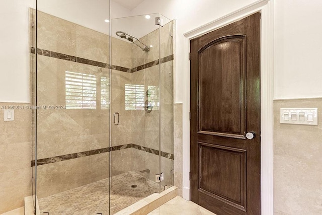 bathroom with tile floors and an enclosed shower