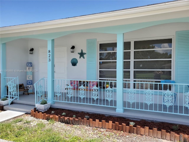 doorway to property with a porch