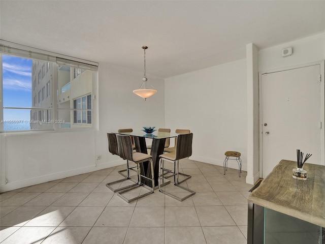 dining space with light tile flooring