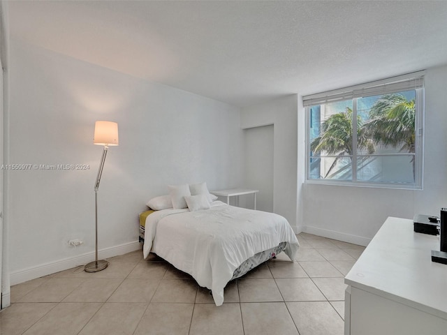 tiled bedroom with a textured ceiling