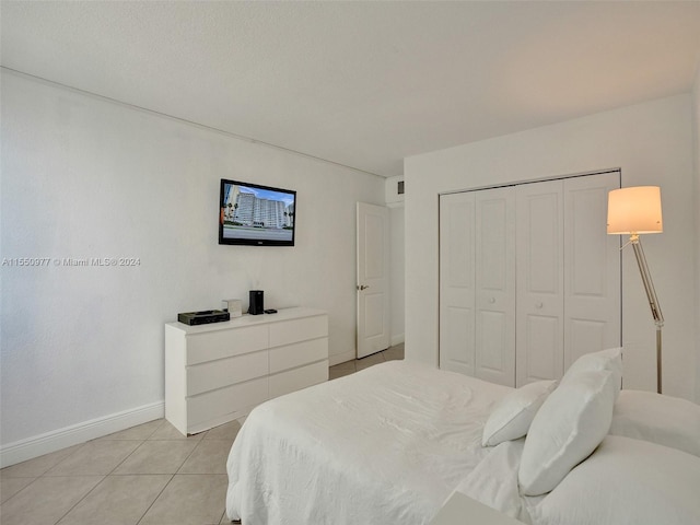 tiled bedroom featuring a closet