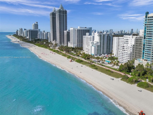 drone / aerial view featuring a water view and a beach view