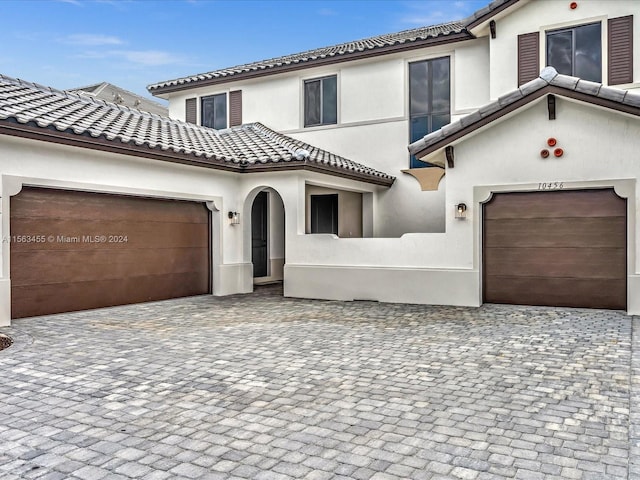 mediterranean / spanish home featuring a garage