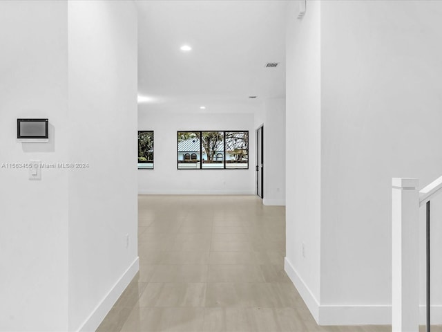 corridor featuring light tile patterned floors