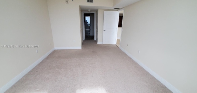 spare room with light colored carpet