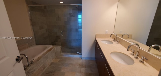 bathroom with double vanity, tile patterned flooring, and independent shower and bath