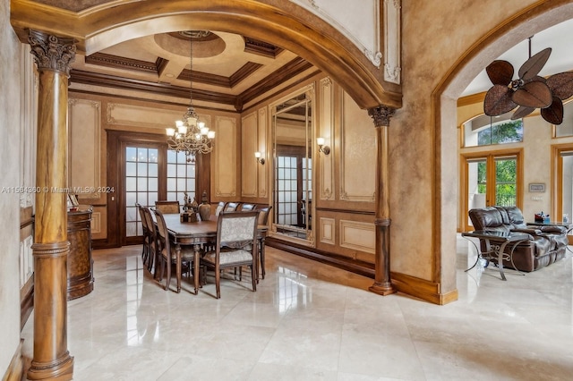 tiled dining area featuring a towering ceiling, crown molding, decorative columns, ceiling fan with notable chandelier, and coffered ceiling