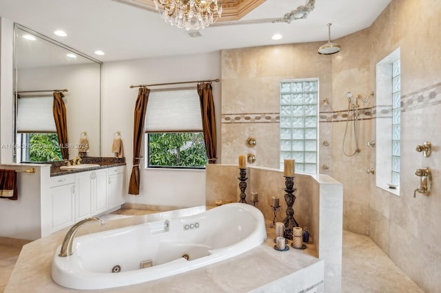 bathroom with a wealth of natural light, separate shower and tub, tile floors, and vanity