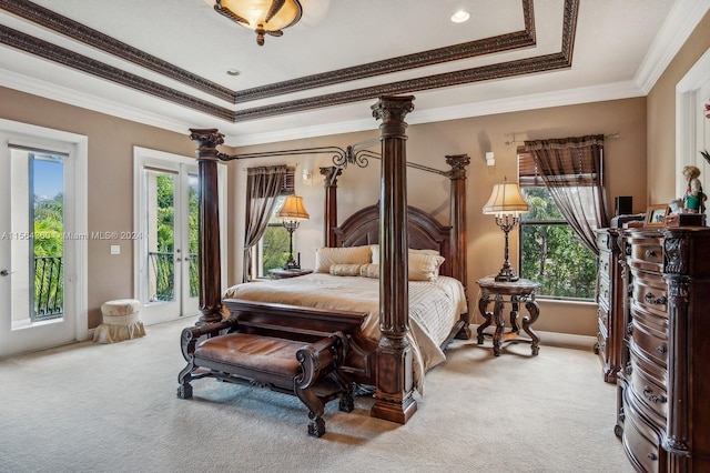 bedroom featuring crown molding, carpet, access to exterior, and a tray ceiling