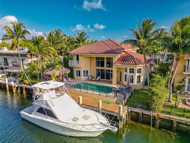 rear view of property featuring a water view and a patio