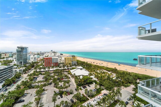 bird's eye view featuring a water view and a beach view