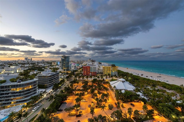 bird's eye view with a water view, a view of city, and a view of the beach