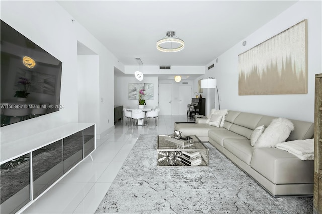 living room with light tile patterned flooring and visible vents