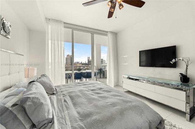 bedroom with access to exterior, light tile patterned floors, floor to ceiling windows, and a ceiling fan