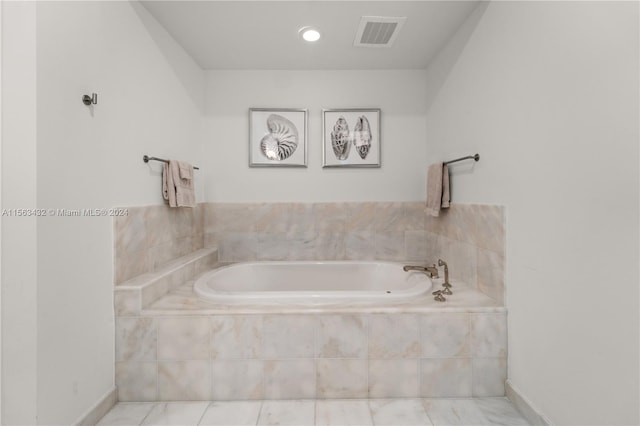 full bathroom featuring a garden tub, baseboards, and visible vents