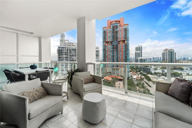 balcony with a view of city and an outdoor hangout area