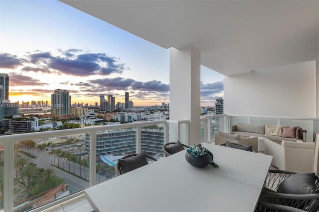 balcony featuring outdoor dining area, a city view, and outdoor lounge area