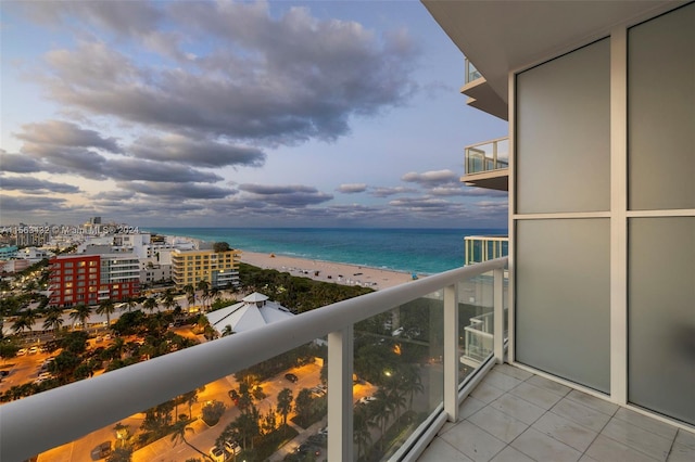 balcony with a water view and a beach view