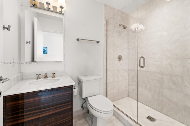 bathroom featuring toilet, a stall shower, and vanity