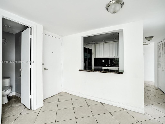 unfurnished room featuring light tile flooring