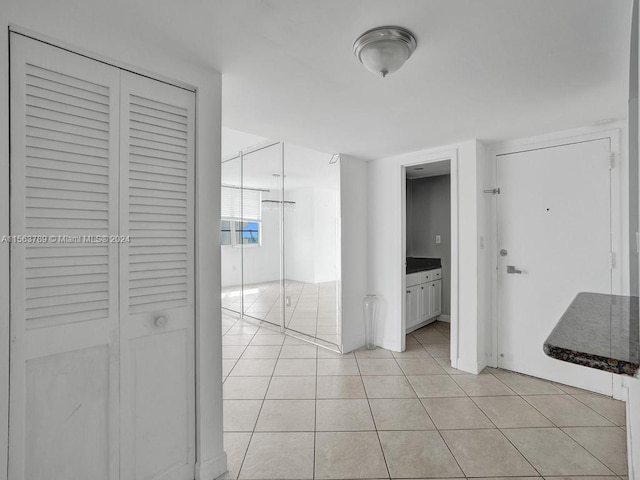 hallway featuring light tile flooring