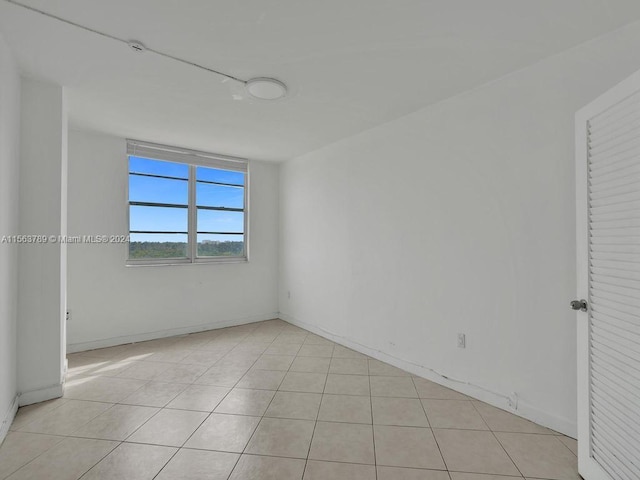 unfurnished room with light tile floors