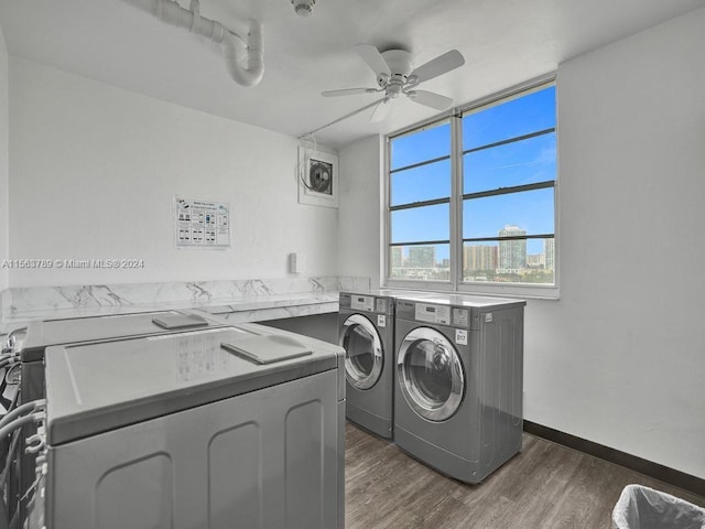 laundry room with dark hardwood / wood-style flooring, ceiling fan, and washing machine and clothes dryer