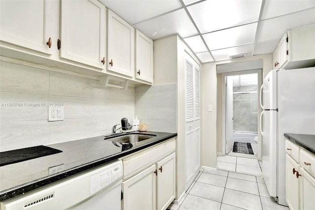 kitchen featuring white cabinets, a drop ceiling, white appliances, sink, and light tile patterned floors